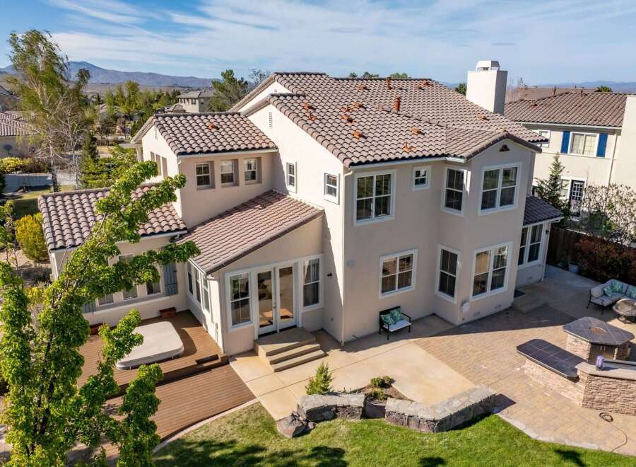Discover luxury living in this stunning two-story home, featuring a beautiful tile roof and a spacious outdoor area.