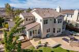 Discover luxury living in this stunning two-story home, featuring a beautiful tile roof and a spacious outdoor area.