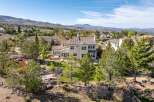 This stunning property boasts a luxurious design with a beautiful tile roof and expansive windows.