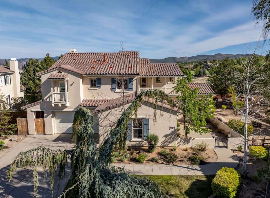This stunning property boasts a beautiful exterior with a tile roof and a charming balcony.