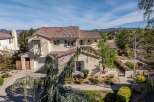 This stunning property boasts a beautiful exterior with a tile roof and a charming balcony.