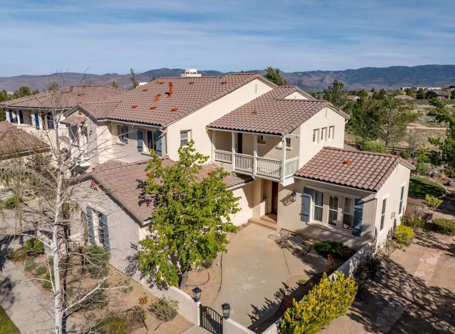 This stunning property boasts a beautiful exterior with a tile roof and a welcoming entrance.