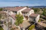 This stunning property boasts a beautiful exterior with a tile roof and a welcoming entrance.