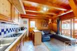 This charming property boasts a cozy kitchen with wooden cabinetry and a modern cooktop.