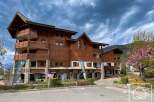 Discover a charming wooden chalet nestled in a picturesque mountain setting.