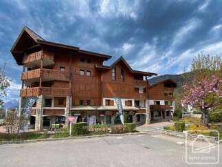 Discover a charming wooden chalet nestled in a picturesque mountain setting.