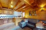 This charming property boasts a warm and inviting interior, featuring a cozy living space with a comfortable leather sofa.