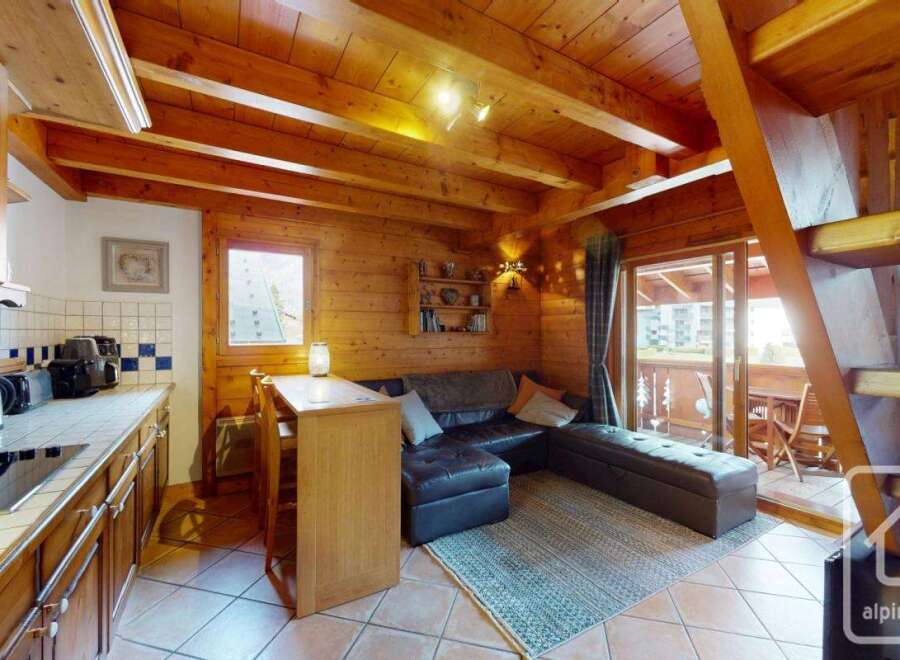 Discover the charm of this cozy property, featuring a warm wooden interior and a well-equipped kitchen.
