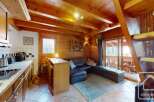 Discover the charm of this cozy property, featuring a warm wooden interior and a well-equipped kitchen.