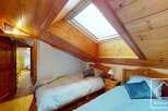 Discover the charm of this cozy bedroom featuring a unique sloped ceiling and a skylight that floods the space with natural light.