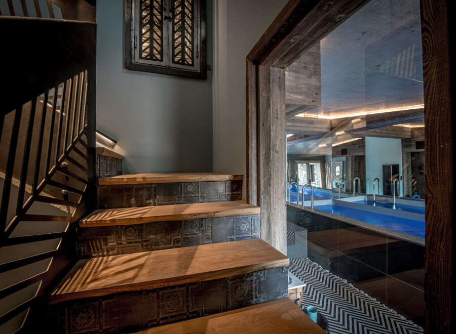 Step into luxury with this stunning property featuring a beautifully designed staircase leading to a private indoor pool.
