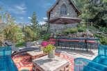 Discover a charming stone cottage with a delightful outdoor patio, perfect for enjoying the mountain views.