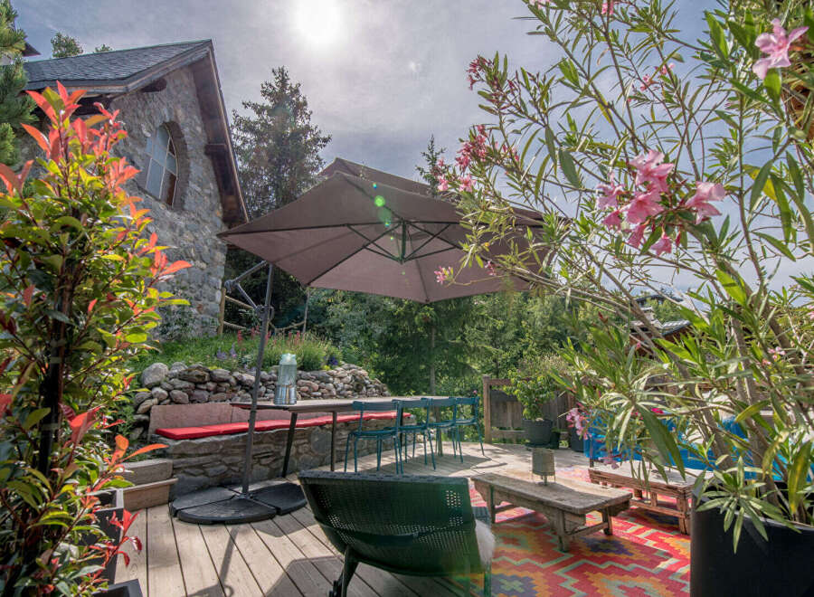 Escape to your own private oasis with this stunning property! Enjoy outdoor dining and relaxation on the spacious deck, complete with a stylish umbrella and comfortable seating.