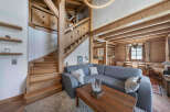 Step into rustic elegance with this stunning property featuring a beautifully crafted wooden staircase and exposed beams.