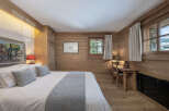 Experience the warmth and charm of this cozy bedroom, featuring stunning wood paneling that exudes rustic elegance.
