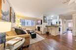Discover this stunning property featuring a cozy living room with a fireplace and a modern kitchen.