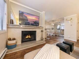 This stunning property boasts a cozy living room with a fireplace, perfect for relaxing evenings.