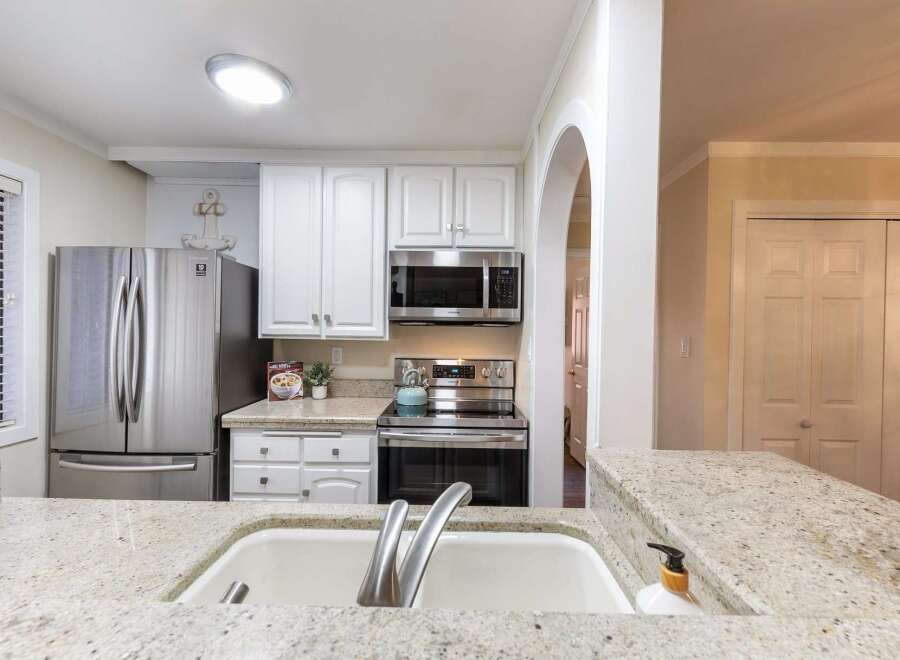 This stunning kitchen boasts modern appliances and ample counter space, perfect for culinary enthusiasts.