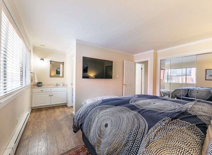 Step into this inviting bedroom, featuring a modern design and ample natural light.