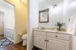 This charming bathroom features a stylish vanity with ample storage and a beautiful countertop.