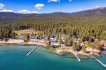 Discover a stunning lakeside property nestled amidst towering pine trees.