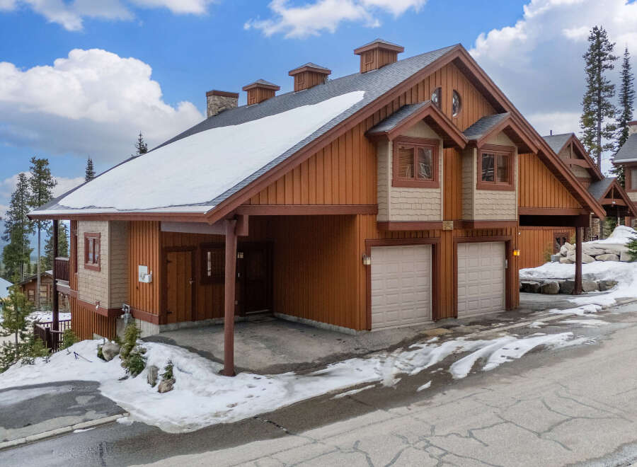 Discover the charm of this stunning mountain home, featuring a beautiful exterior with a combination of wood and stone accents.