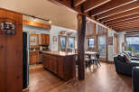 This stunning property boasts a rustic charm with its wooden beams, hardwood floors, and a cozy fireplace.