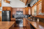 This stunning kitchen boasts rustic charm with its wooden cabinetry and stainless steel appliances.