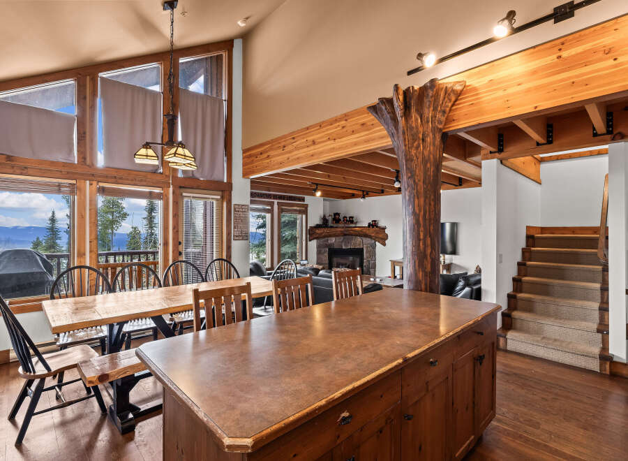 Experience the charm of this stunning property, featuring a spacious kitchen with a large island and a dining area with breathtaking views.
