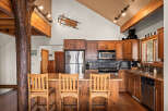 This stunning kitchen showcases rustic charm with its wooden cabinetry and exposed beams.