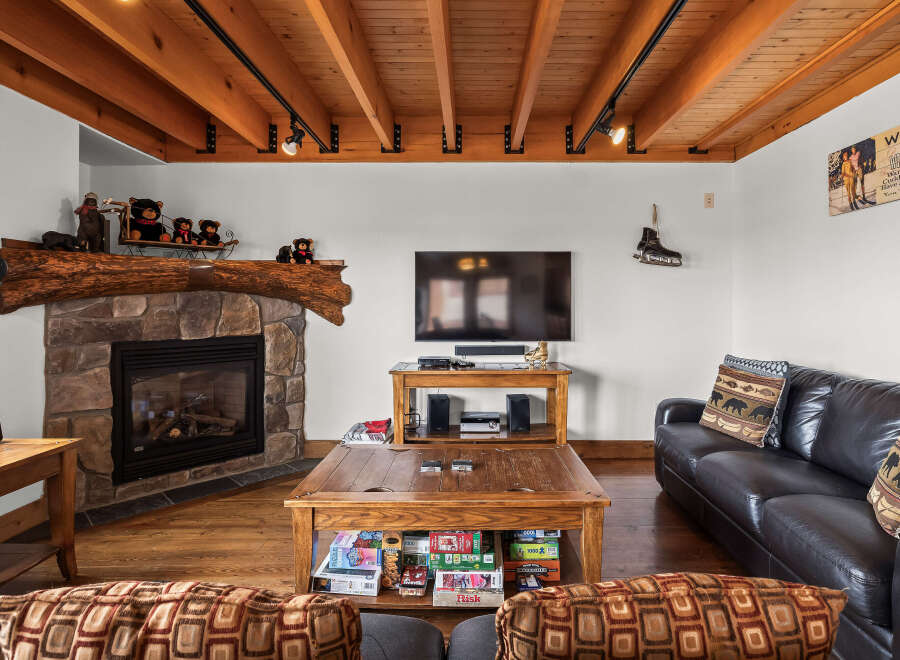 This cozy living room features a stone fireplace, perfect for those chilly evenings.