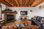 This cozy living room features a stone fireplace, perfect for those chilly evenings.