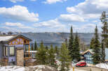 Discover your dream mountain retreat! This stunning property boasts a beautiful exterior with a vibrant color palette and is surrounded by lush greenery and majestic mountain views.