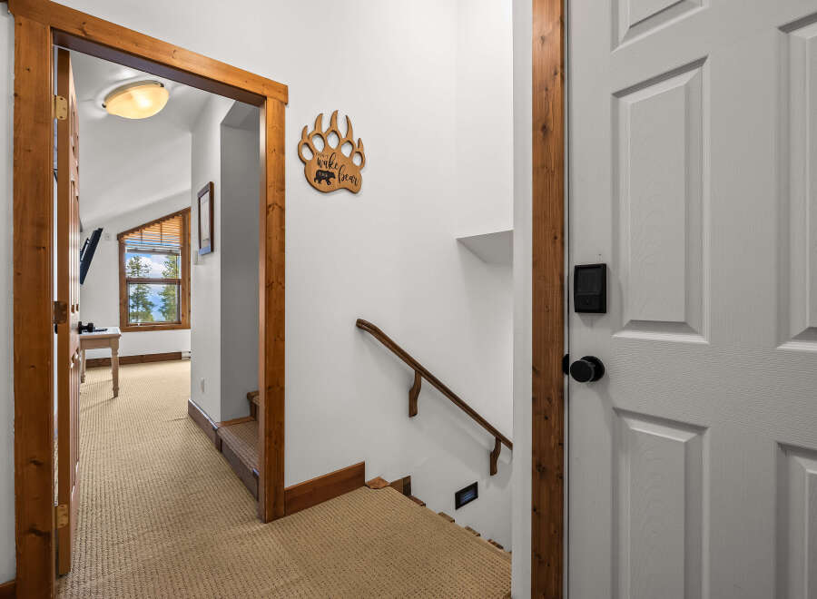 Step into this inviting entryway, featuring a charming wooden door frame and a cozy carpeted floor.
