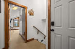 Step into this inviting entryway, featuring a charming wooden door frame and a cozy carpeted floor.