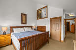 This inviting bedroom features a cozy king-sized bed with a stylish wooden frame, perfect for a relaxing retreat.