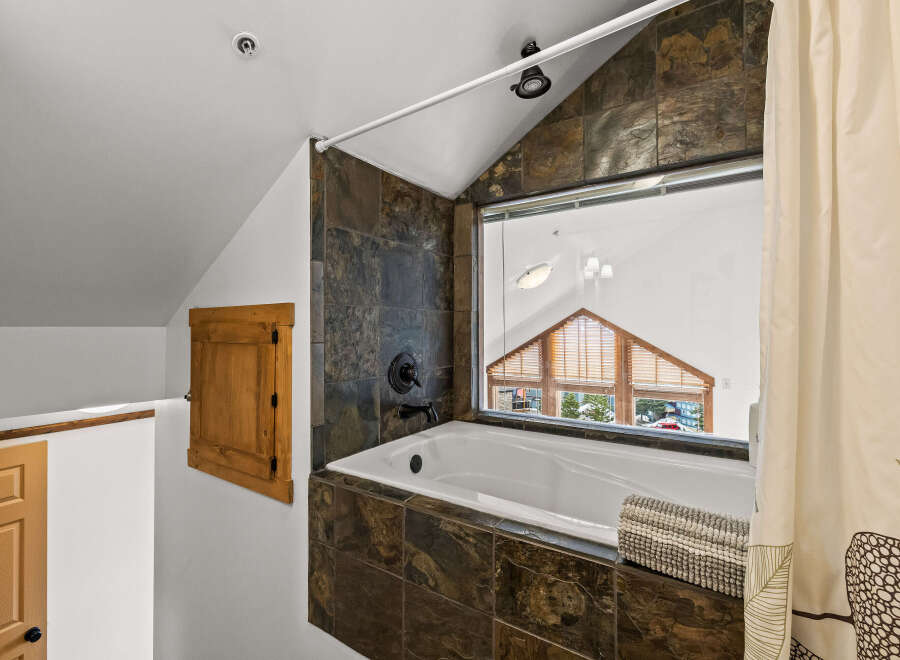 This stunning bathroom boasts a luxurious soaking tub, perfect for unwinding after a long day.