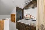 This stunning bathroom boasts a luxurious soaking tub, perfect for unwinding after a long day.