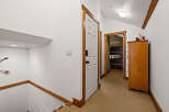 Step into this inviting hallway, featuring a warm, neutral carpet and crisp white walls.