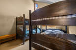 This cozy bedroom features two sets of bunk beds, perfect for accommodating multiple guests or family members.