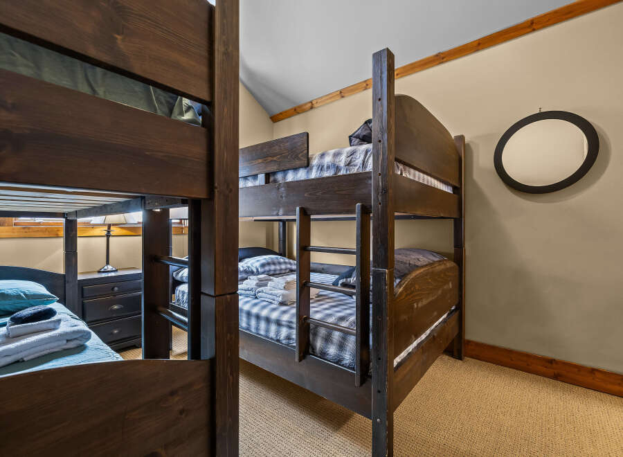This cozy bedroom features custom-built bunk beds, perfect for accommodating guests or family members.