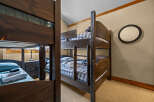 This cozy bedroom features custom-built bunk beds, perfect for accommodating guests or family members.