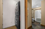 This property features a convenient laundry area with a stacked washer and dryer, perfect for modern living.