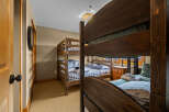 This cozy bedroom features two sets of bunk beds, perfect for accommodating multiple guests or family members.