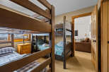 This cozy bedroom features two sets of bunk beds, perfect for accommodating a large family or group of friends.