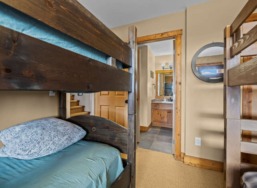 This cozy bedroom features a rustic bunk bed, perfect for accommodating guests or family members.