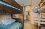 This cozy bedroom features a rustic bunk bed, perfect for accommodating guests or family members.