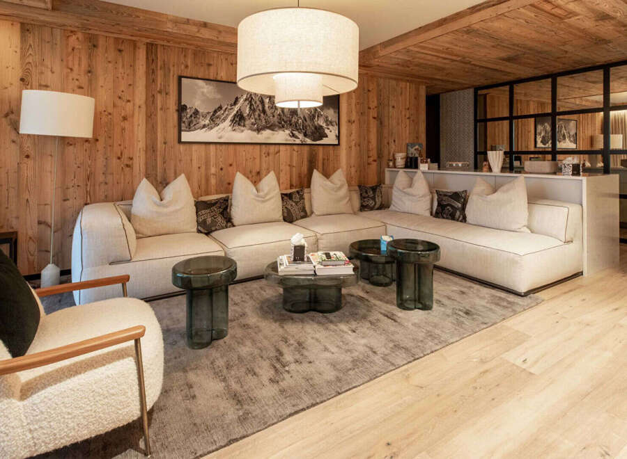 Experience luxury living in this stunning property featuring a cozy living room with a comfortable sectional sofa and stylish coffee tables.
