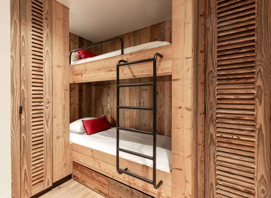 This cozy bunk bed setup is perfect for a vacation home or a kid's room.