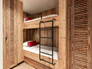 This cozy bunk bed setup is perfect for a vacation home or a kid's room.